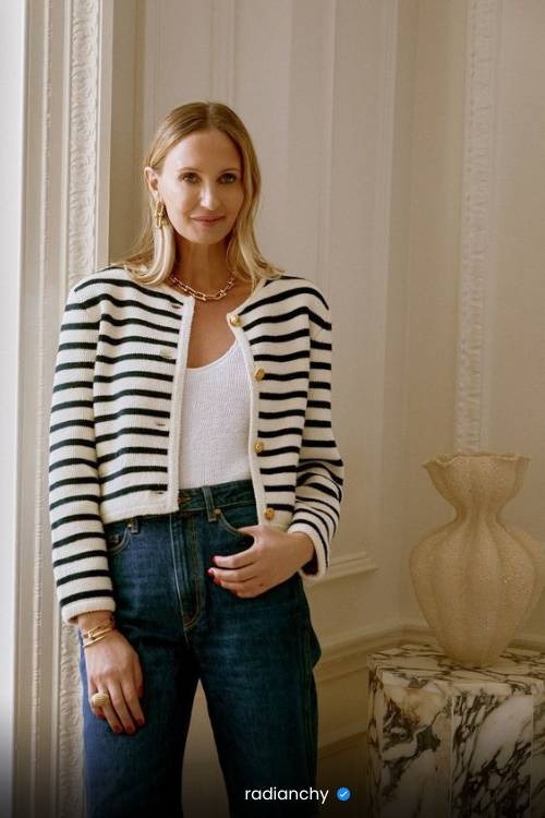 a woman in a striped cardigan sweater and jeans