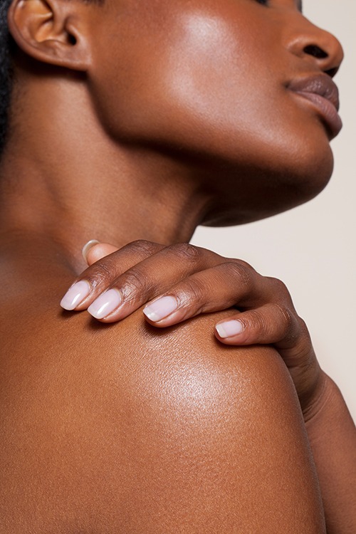 Close-up of woman’s smooth neck and shoulder skin highlighting healthy glow and aesthetic skincare