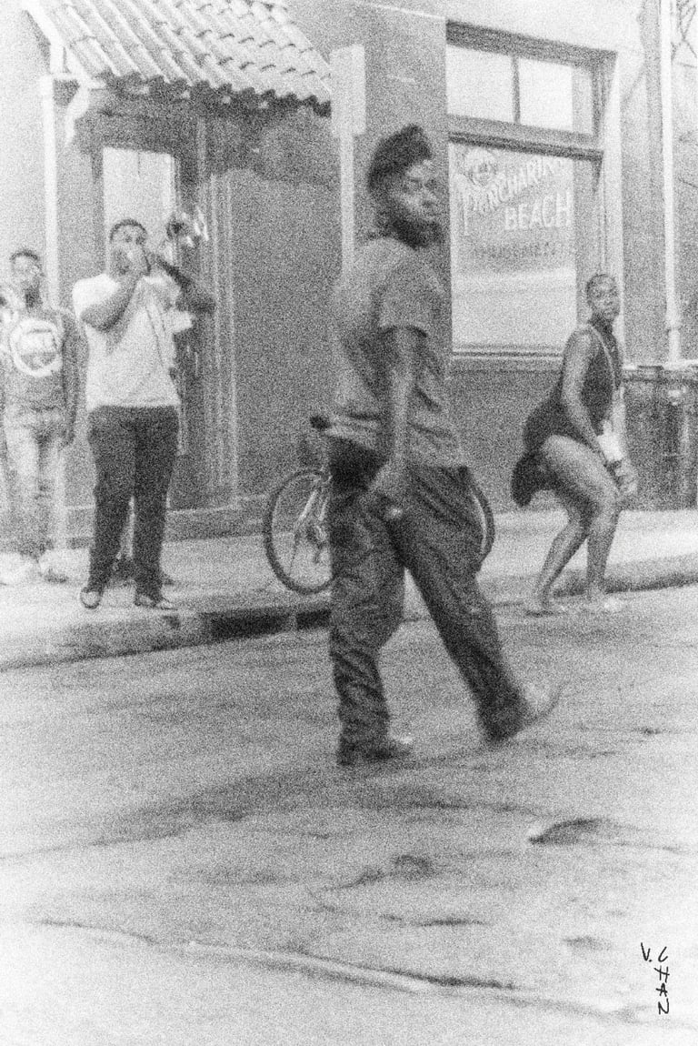 a man and woman dancing in the street with trompet player on the side