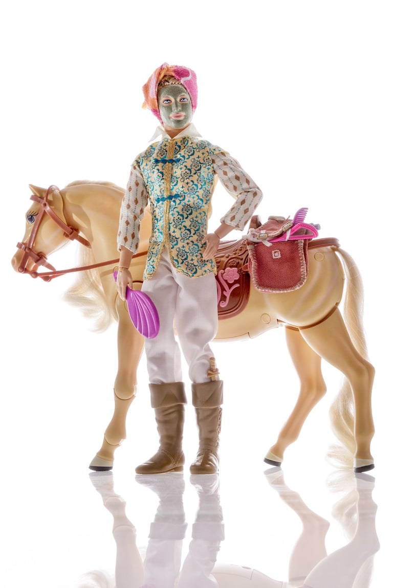 a doll with a horse and a man in a suit