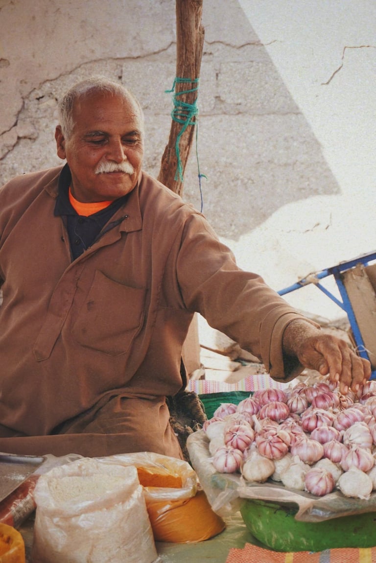man in brown jacket selling spices in souk