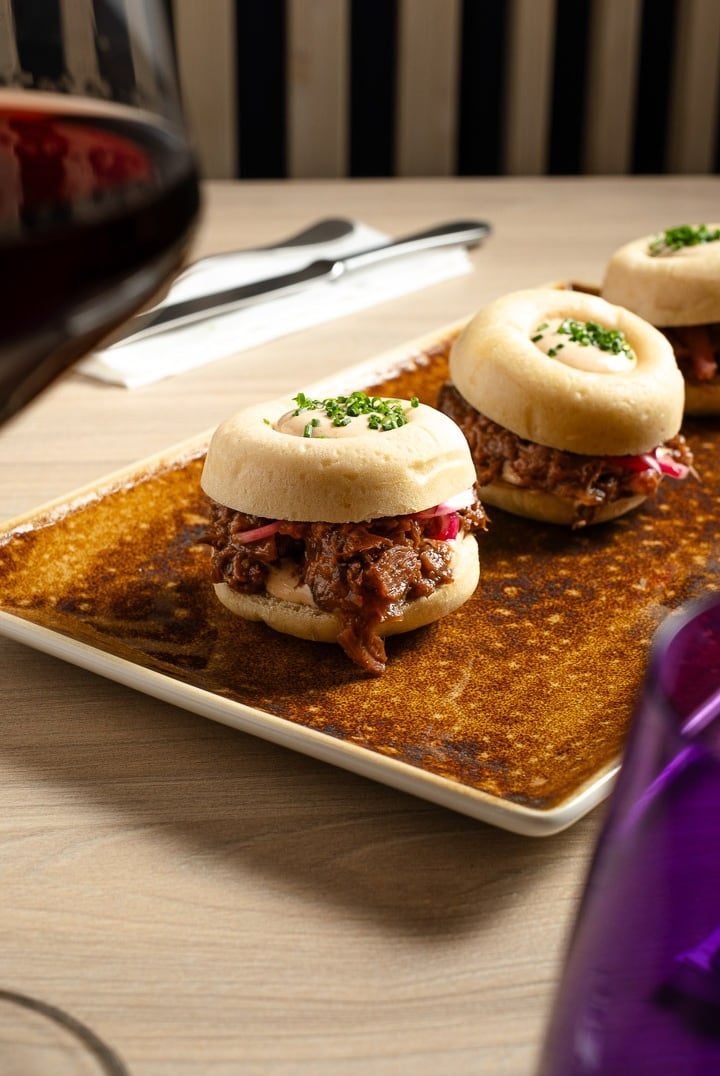 a plate of food and wine glasses on a table