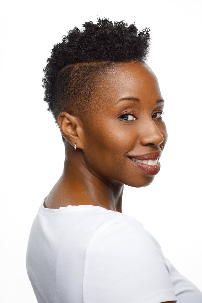 Headshot of Tracie Frank with a sassy over-the-shoulder smile
