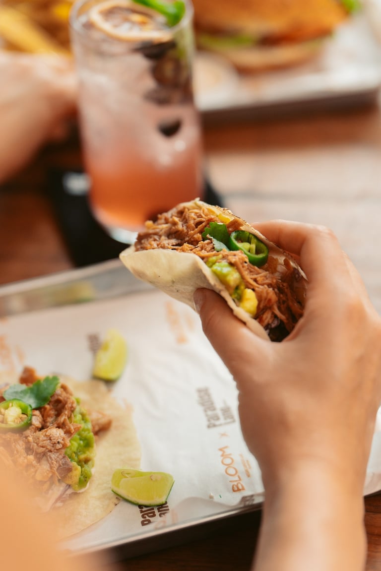 a person holding a sandwich sandwich on a plate