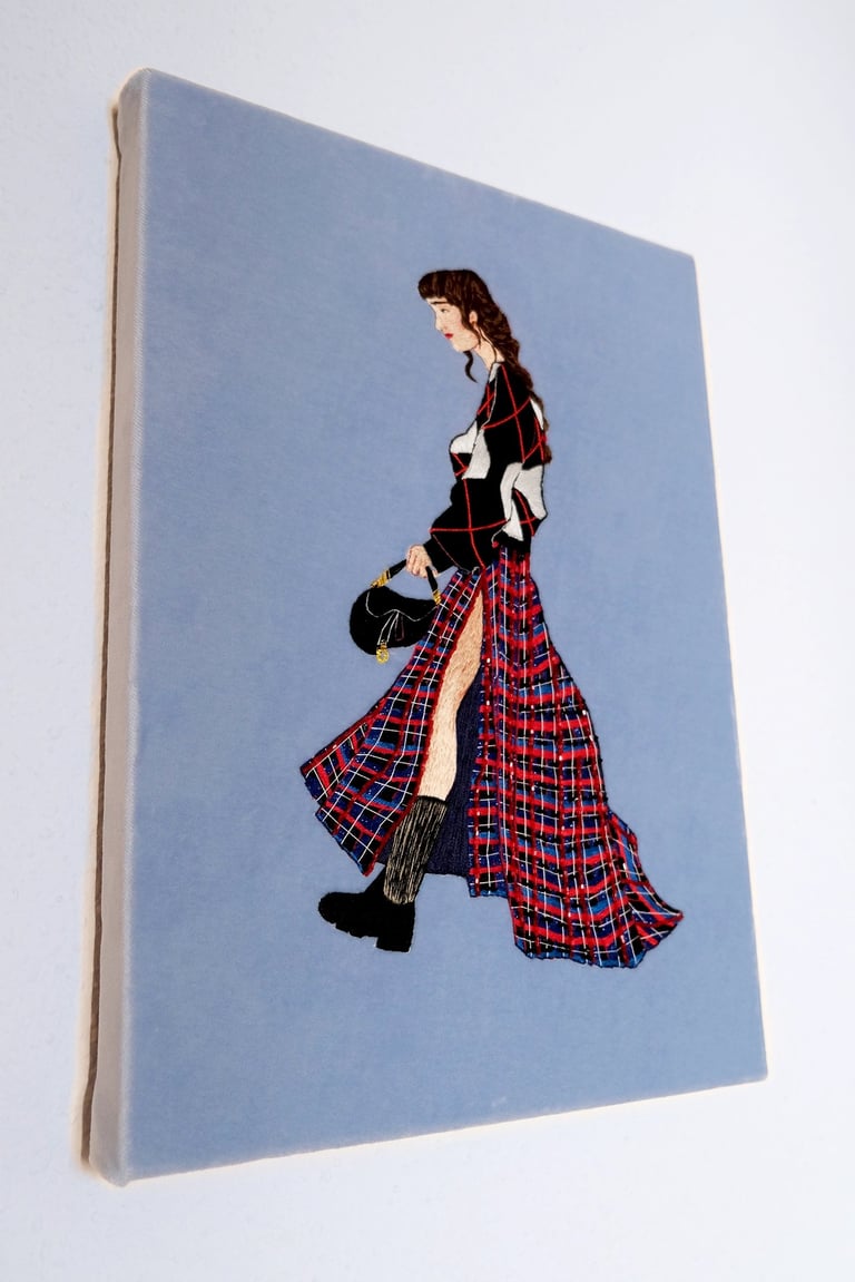 Embroidery artwork of a fashion illustration ; a woman is walking with Dior bag and kilt skirt 
