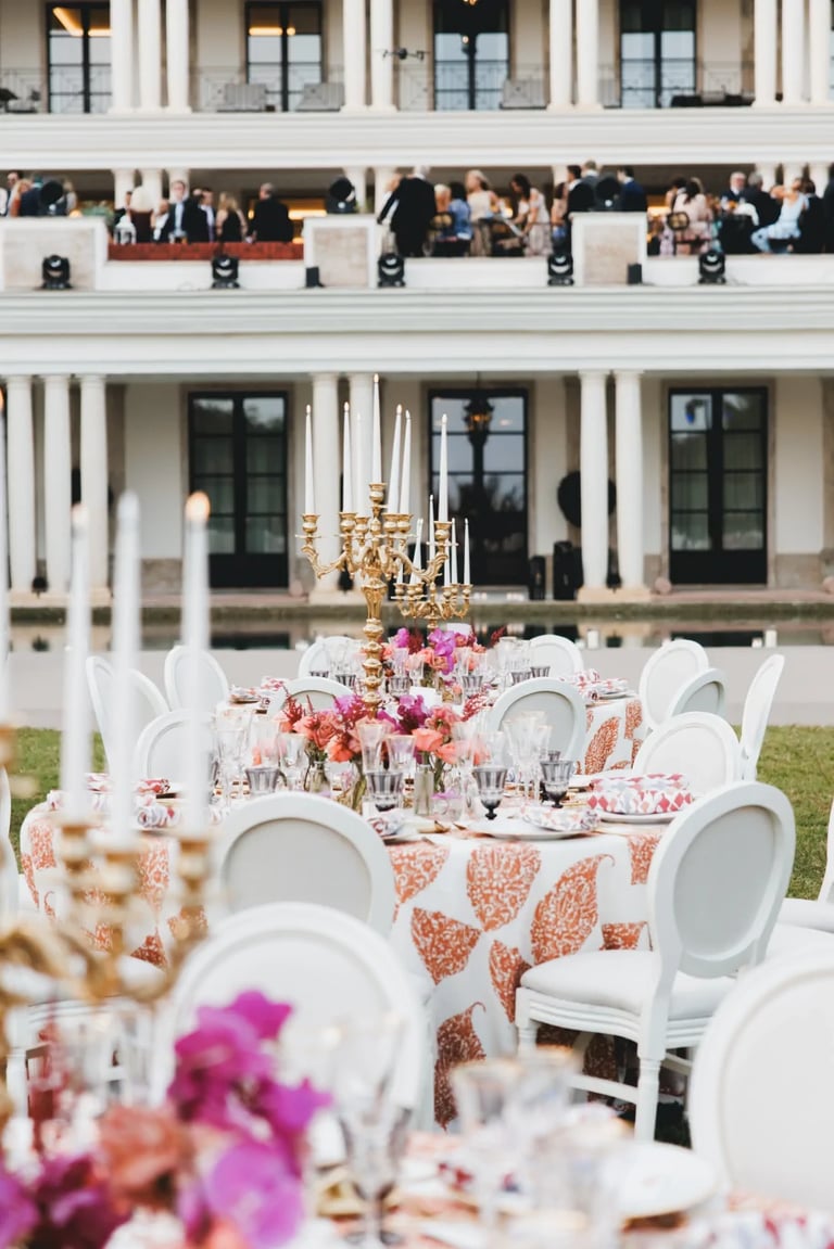 Outdoor banquet setup with round tables and floral décor