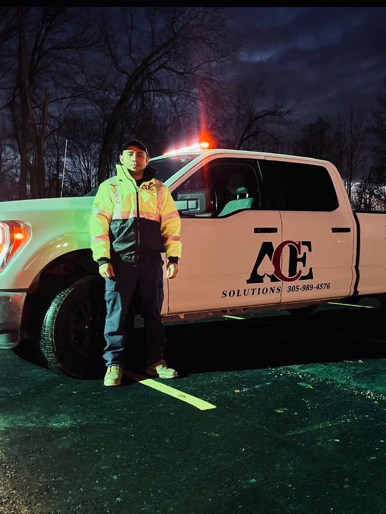 Security guard standing up Infront of a truck