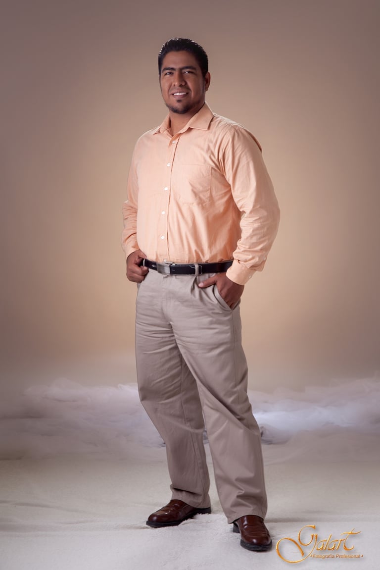 a man in a pink shirt and tan pants