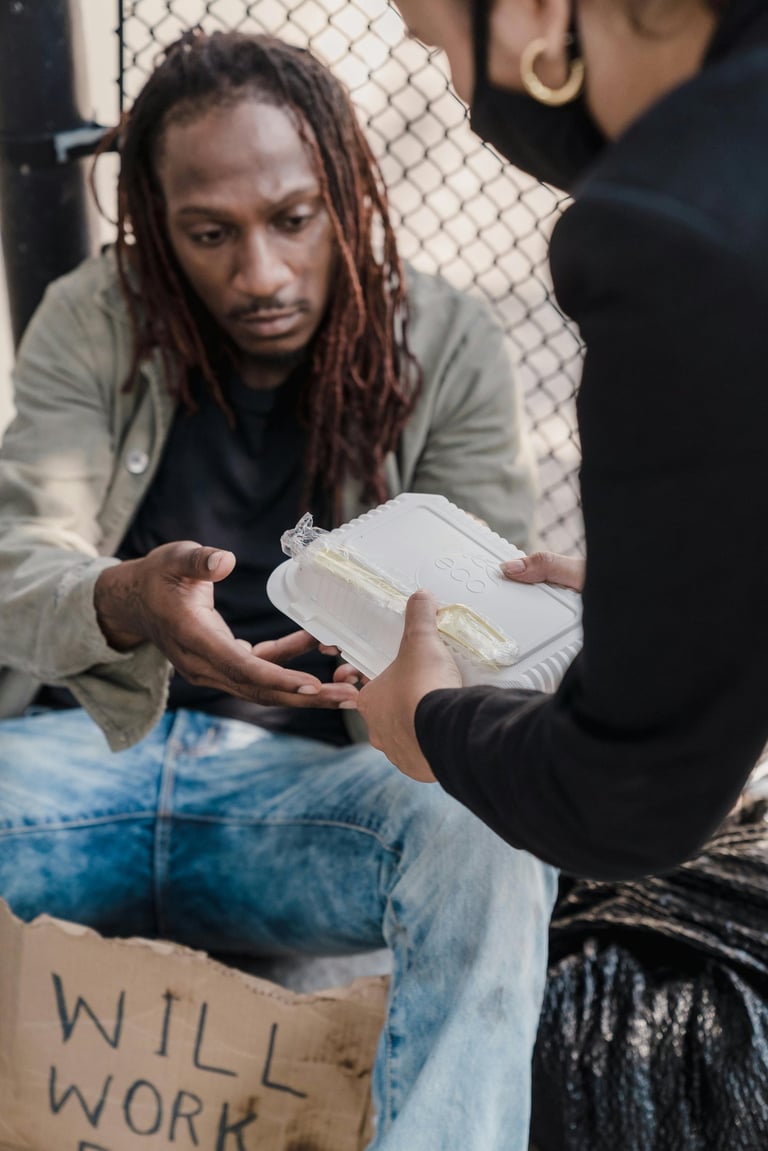 woman handing man a container of food