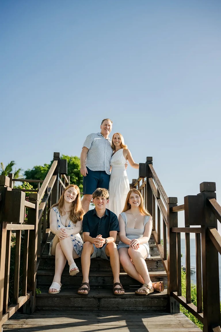 Family gathered at the ocean viewpoint during a family photography session at AYANA Resort Bali