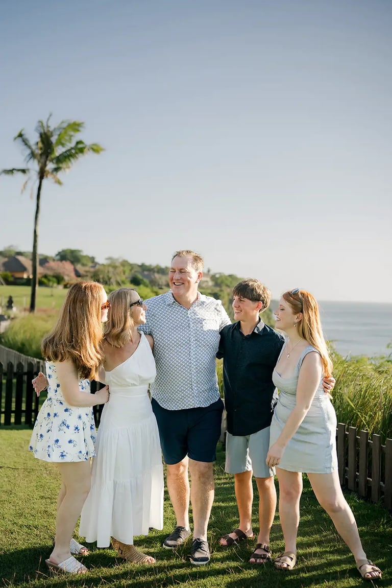 Family portrait overlooking the ocean during a family photography session at AYANA Resort Bali