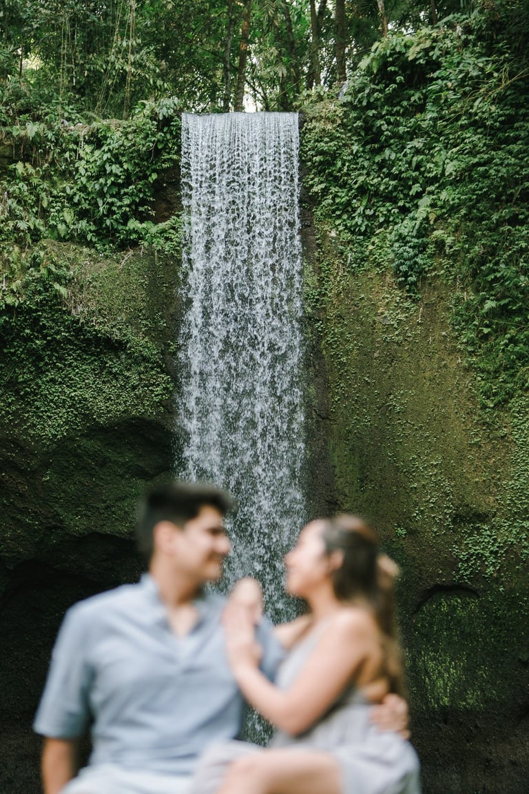 Intimate prewedding couple portrait with Tibumana Waterfall backdrop in Bangli Bali