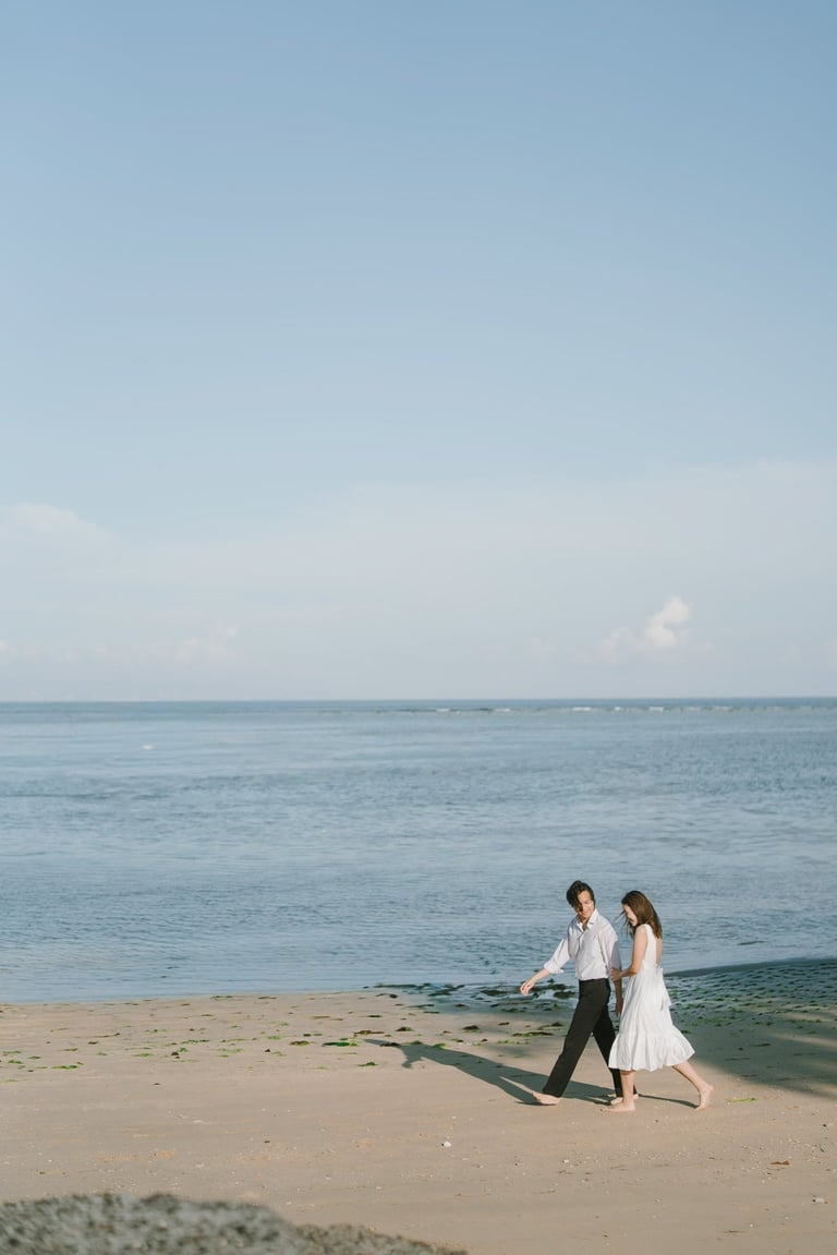 Couple walking along the beach during an intimate photography session at Novotel Bali Benoa in Tanjung Benoa Bali.