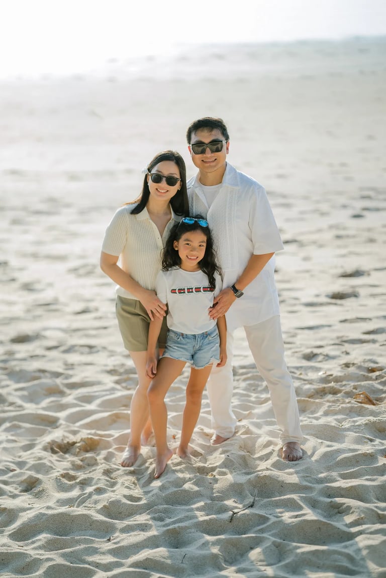 Family portrait captured on the beach at InterContinental Bali Resort during golden hour