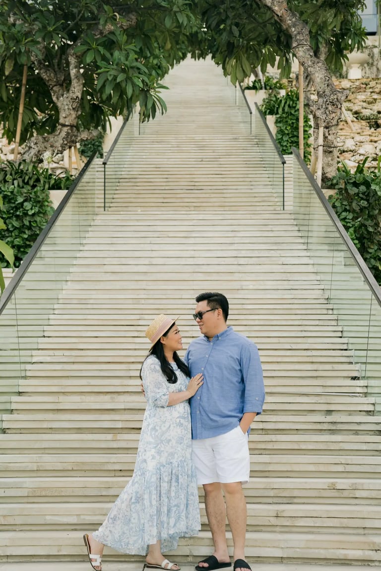 Couple embracing on the Grand Staircase at The Apurva Kempinski Bali