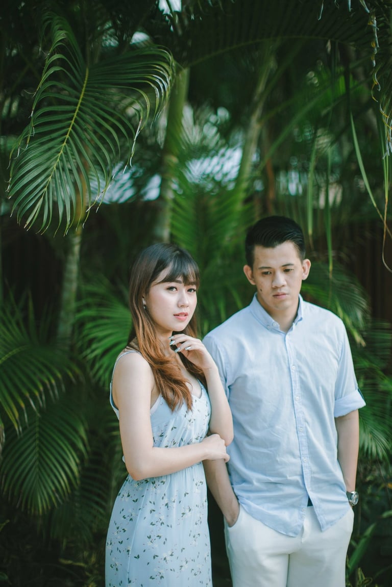 Intimate couple portrait in tropical garden at Sofitel Bali Nusa Dua Beach Resort.