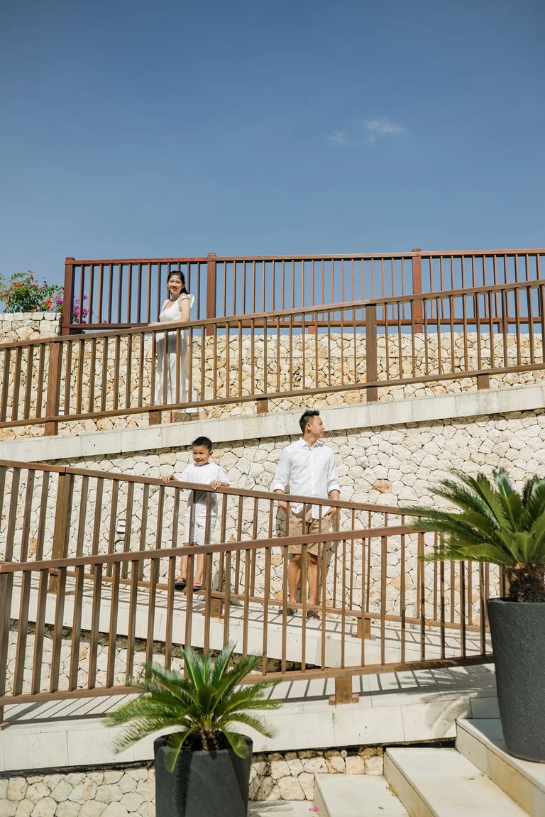 Family walking together through the resort during a natural family session at Anantara Uluwatu Bali.