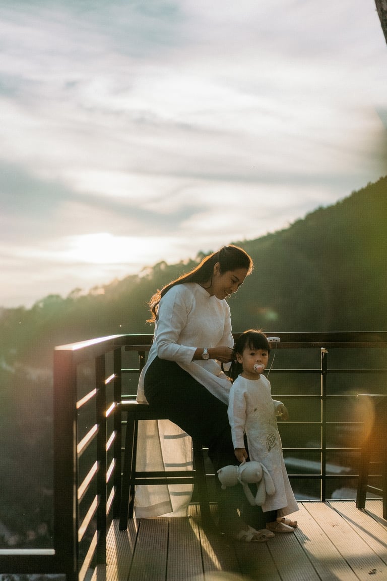 a woman sitting on a bench with her two children