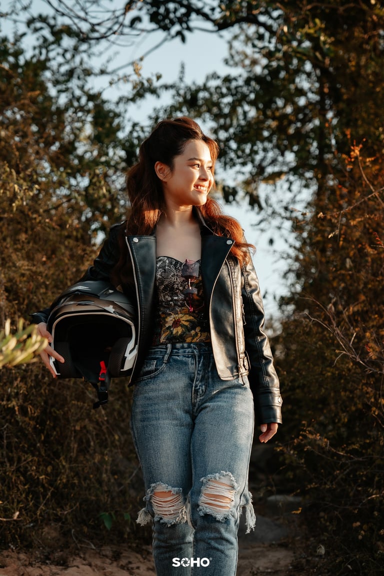 a woman in a leather jacket and jeans