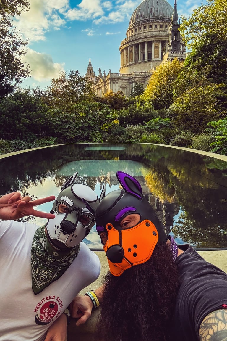 Two friends outdoors posing in pup masks.