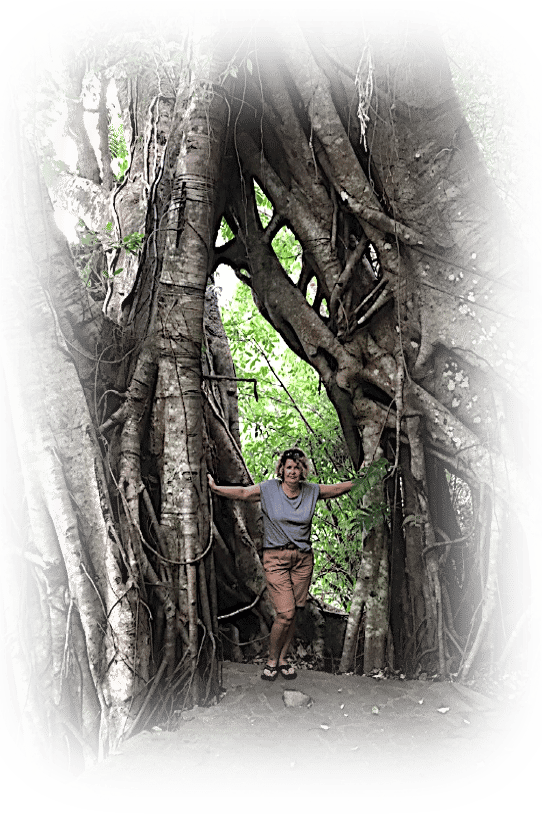 a woman standing in front of a tree