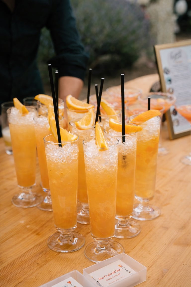 Refreshing tropical cocktails with crushed ice and citrus slices served at an outdoor bar.