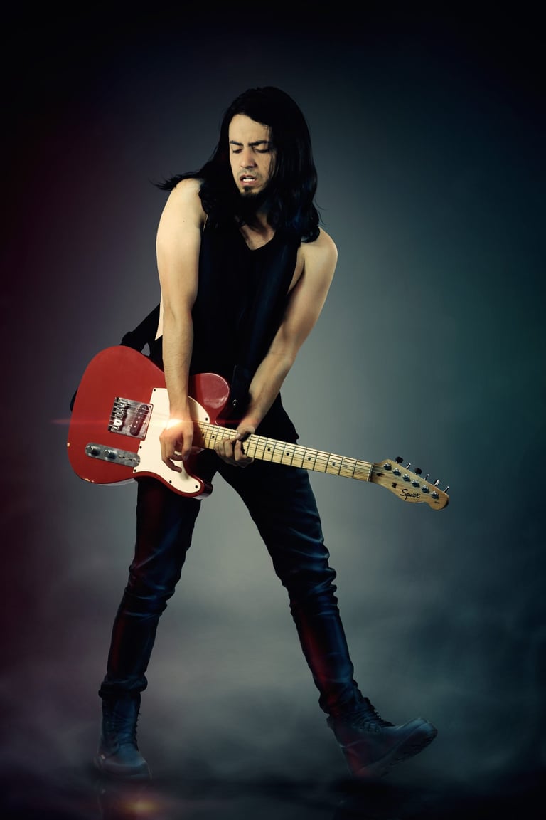 a man with long hair and a guitar