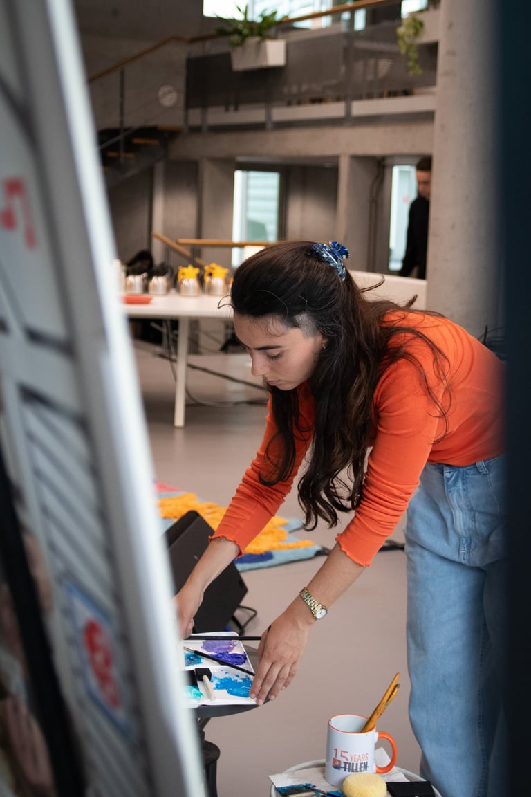 Sofia is painting a canvas for a live art performance. Photo by Emmanuelle Dekkers