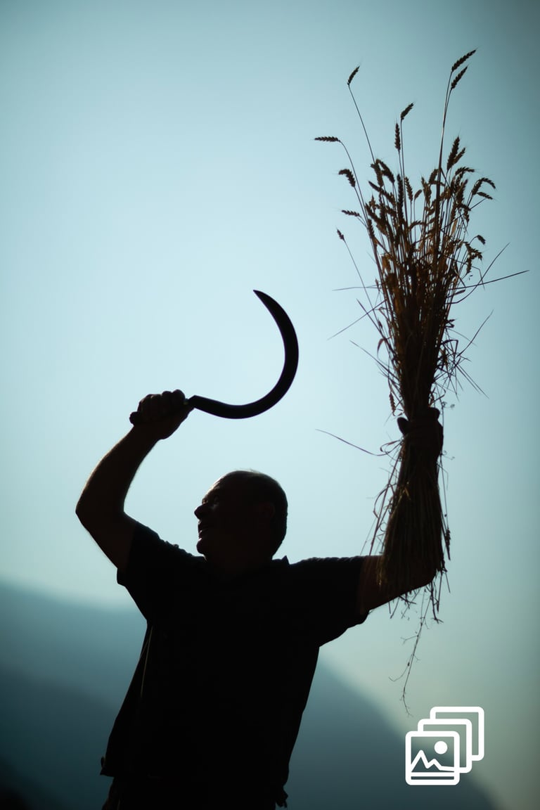 a man holding a large piece of hay with a knife in his hand