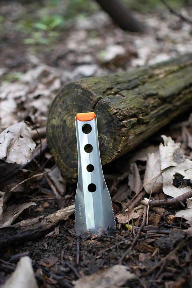boglerco trowel stuck on ground by log