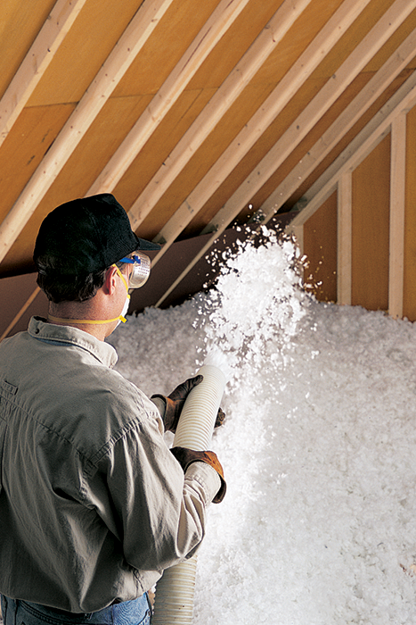 a man in a hat and gloves is holding insulation