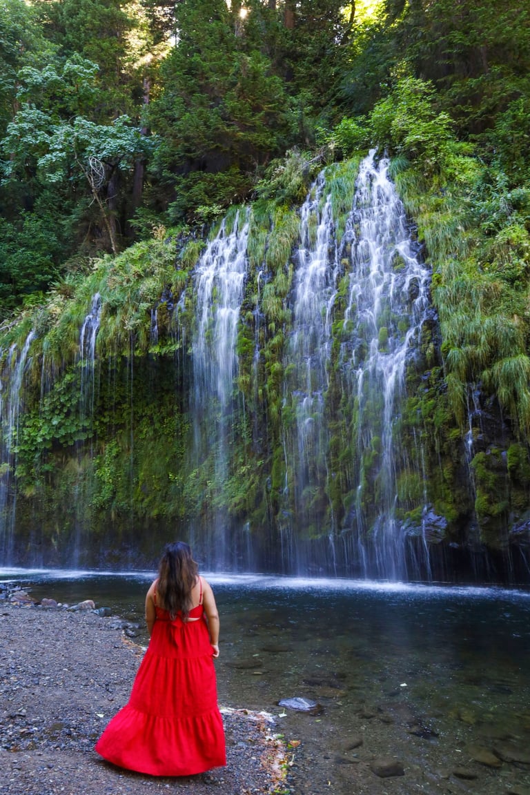 california, waterfalls, mossbrae falls, a woman in a red dress standing in front of a waterfall