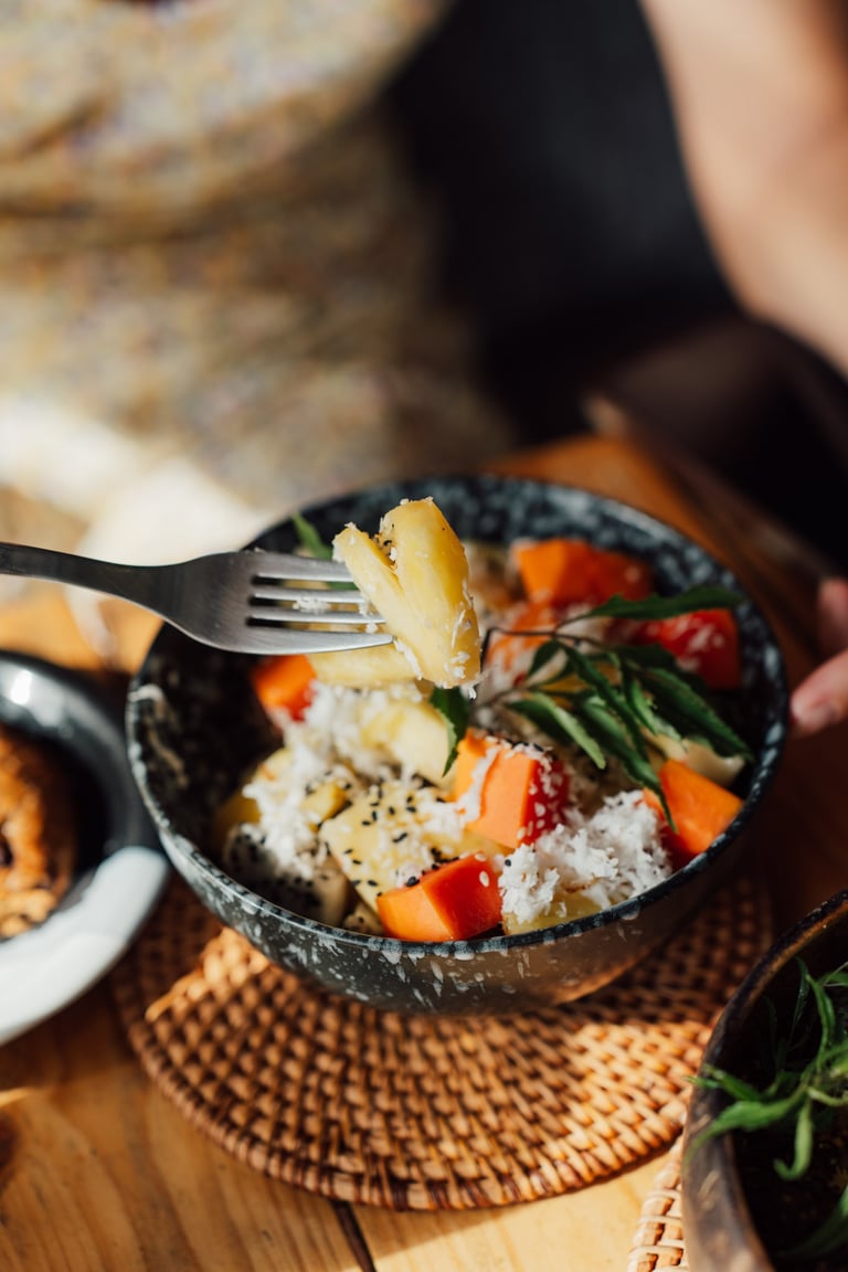 a person holding a fork and fork in a bowl
