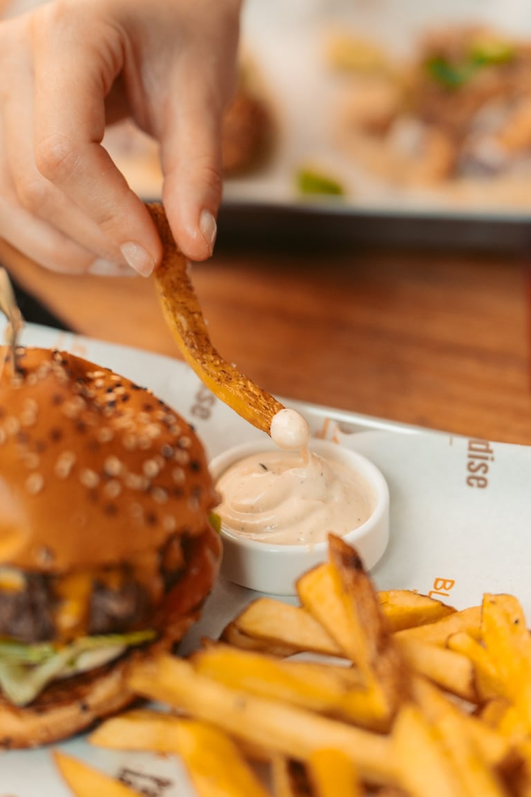 a person is holding a piece of food in front of a hamburger burger king