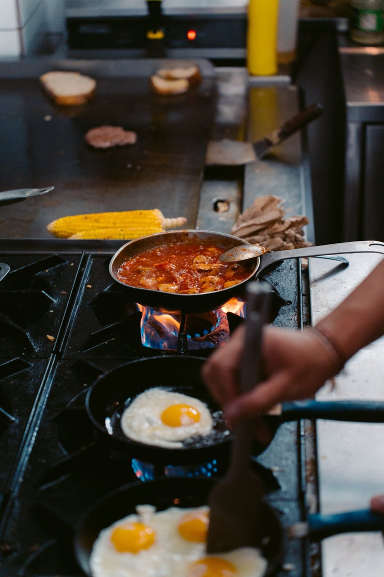 a person cooking food on a stove top