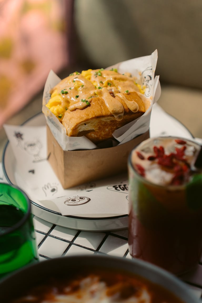 a table with a bowl of soup and a sandwich