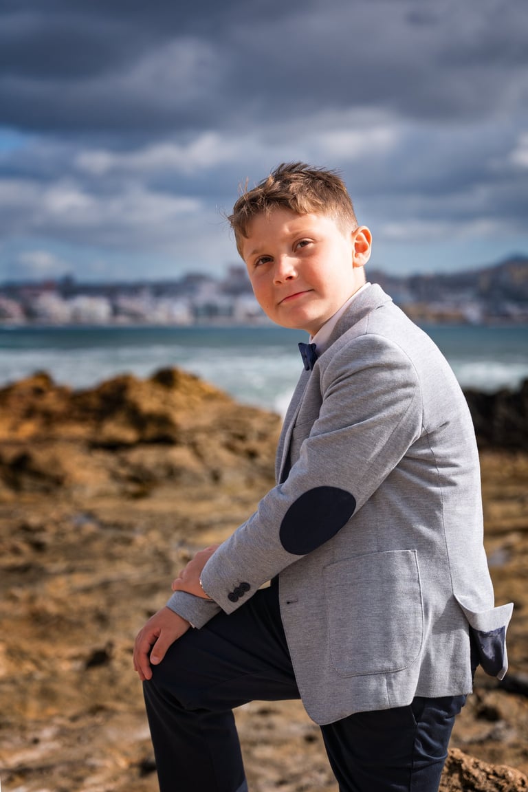 a young boy in a suit and tie