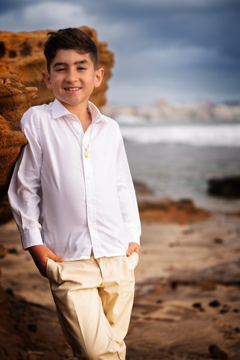 a boy in a white shirt and tan pants
