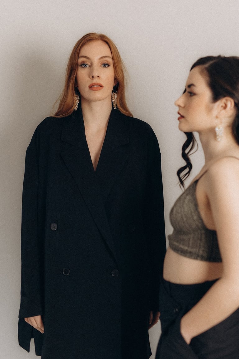 two women standing next to each other in a room