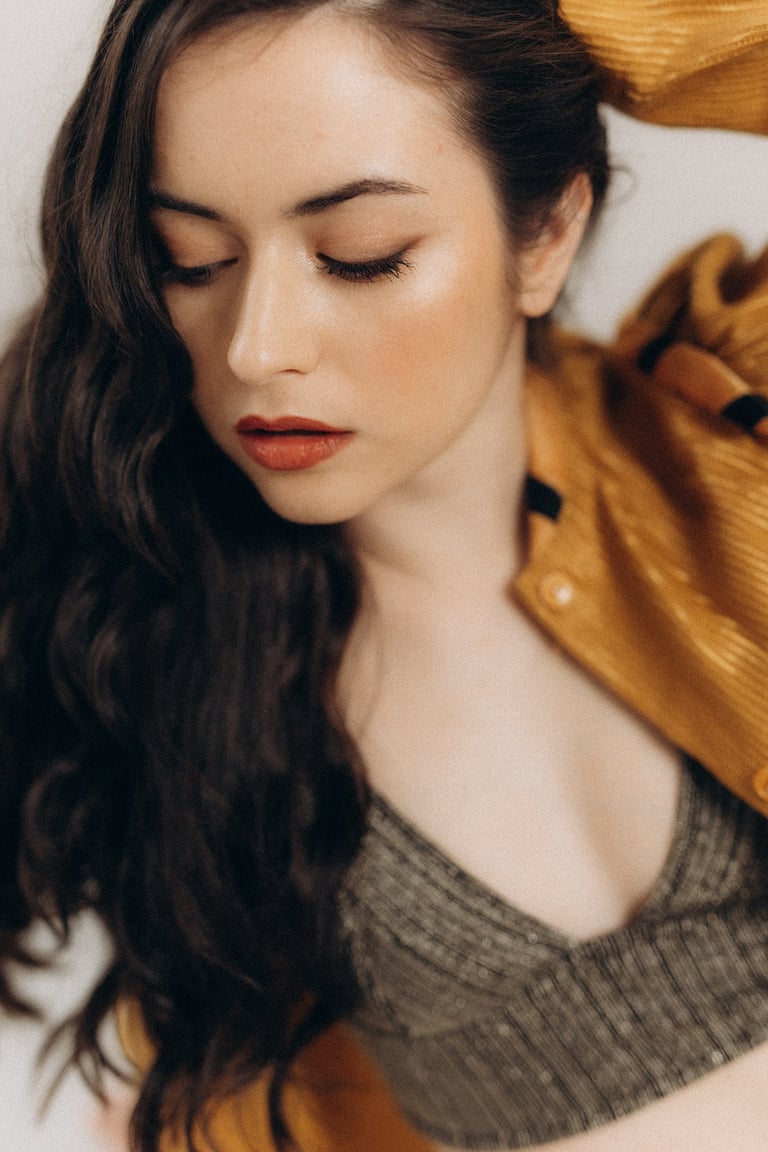 a woman with long hair and a yellow jacket