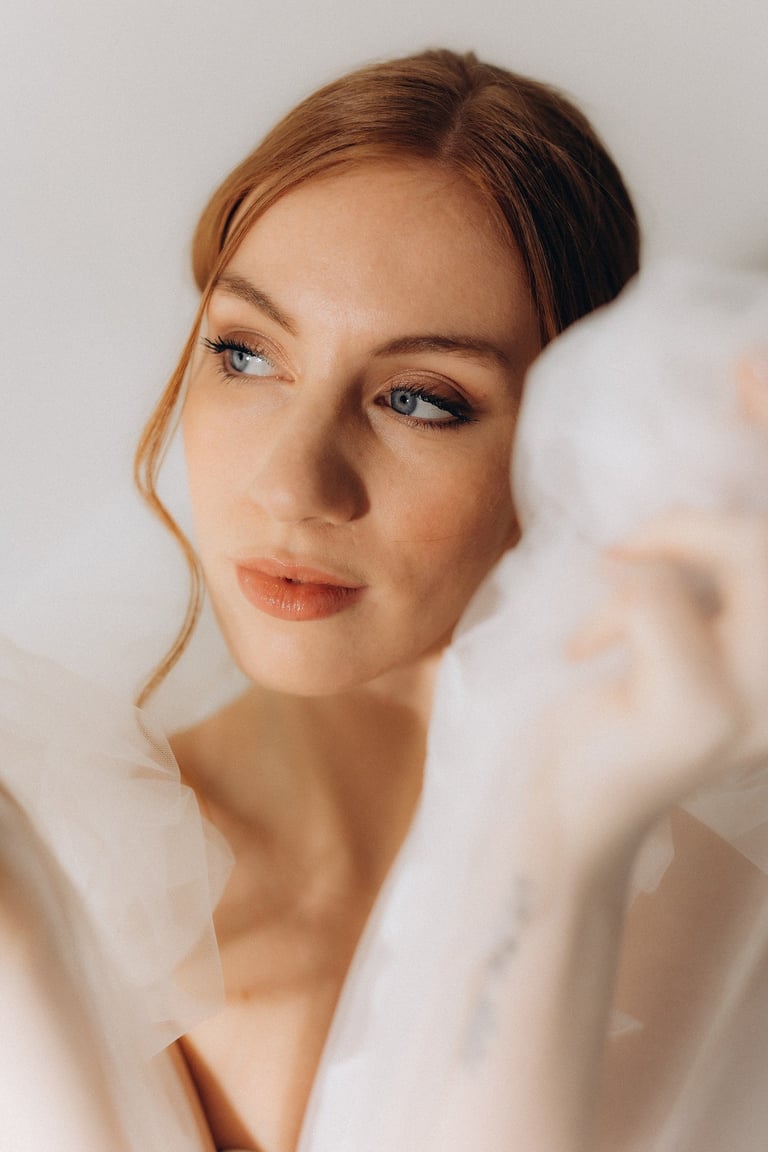 a woman in a white dress with a veil on her head
