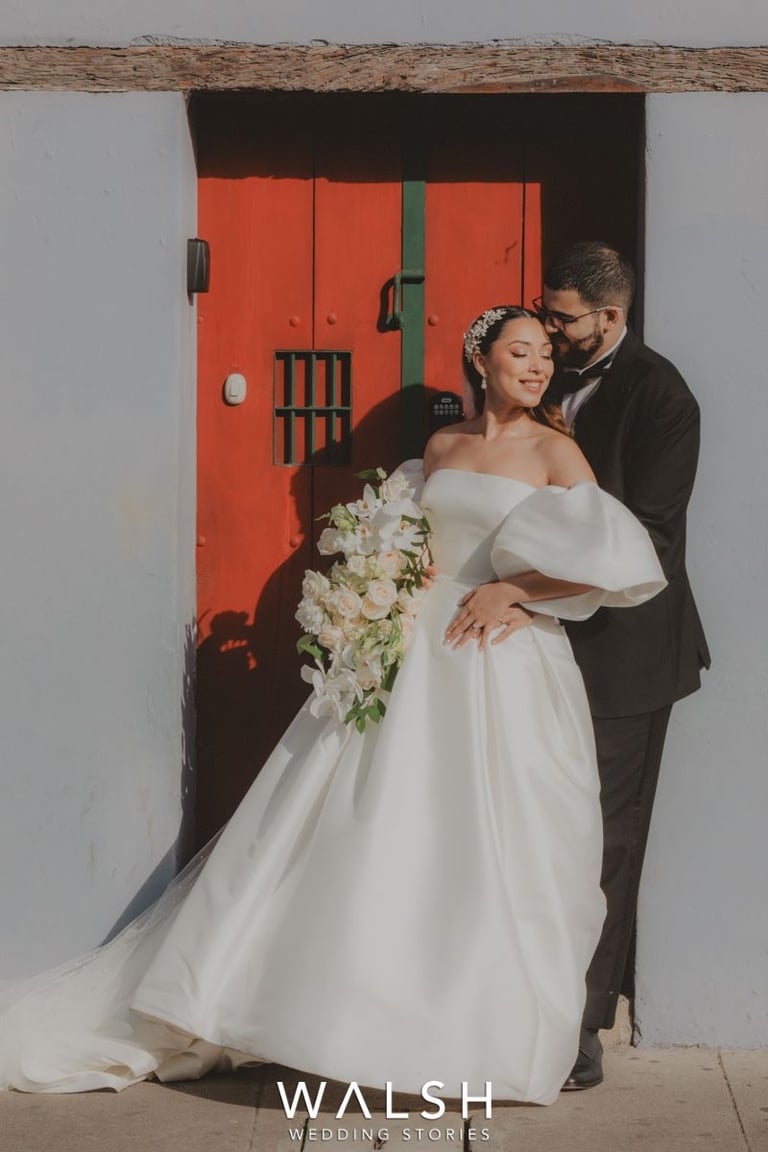 Antigua Guatemala Wedding Photographer-bride and groom resting on red door