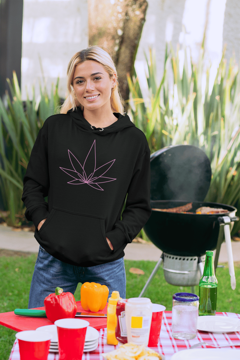 a beautiful woman wearing a black hoodie with a pink cannabis leaf on the front