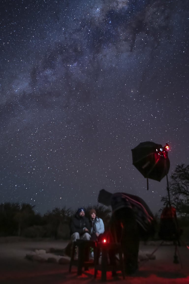 a group of people sitting under the stars