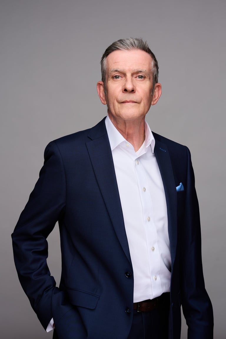 Professional headshot of Martin Wacker in a navy blue suit and white shirt.