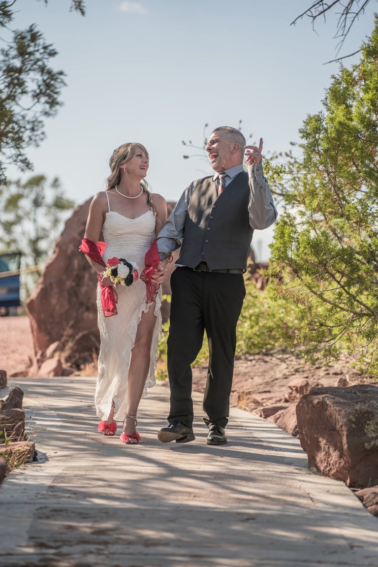 a man and woman walking down a path