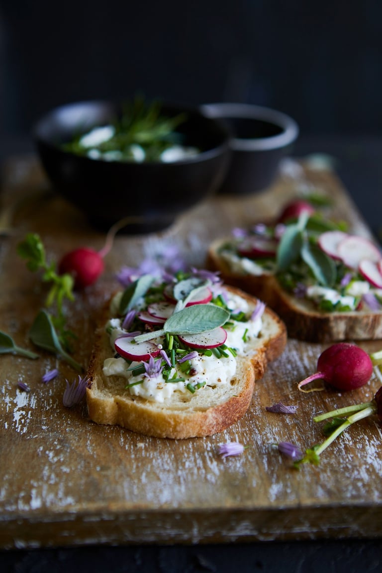 a wooden cutting board with a bowl of vegetables