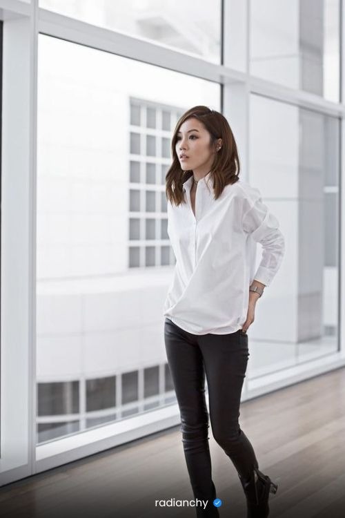a woman in a white shirt and black pants