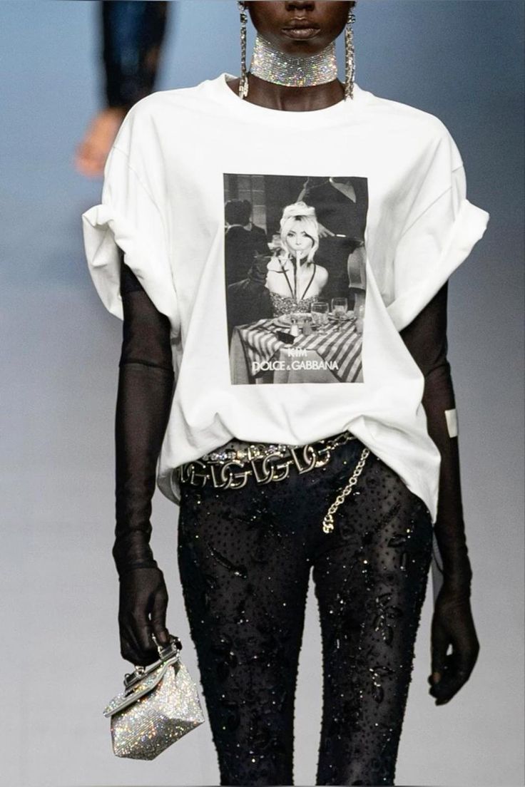 a woman in a white shirt and black pants