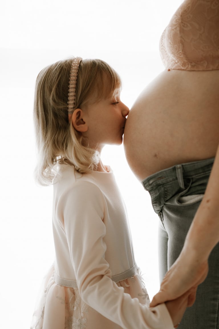 toddler kissing her mum's pregnant belly in studio - Littlehampton, Adelaide Hills